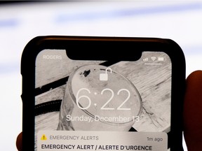 A phone displays a provincewide Amber Alert.