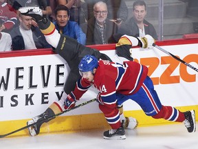 Canadiens’ Nick Suzuki (14) collides with Vegas Golden Knights’ Keegan Kolesar during first period NHL hockey action in Montreal, Saturday, Nov. 5, 2022.