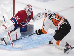 Canadiens goaltender Jake Allen makes a save against Philadelphia Flyers’ Morgan Frost during second period NHL hockey action in Montreal on Saturday, Nov. 19, 2022.