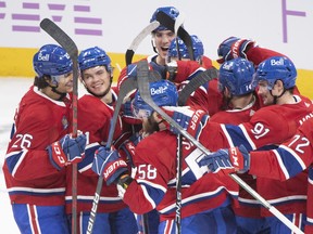Canadiens players celebrate after defeating the Philadelphia Flyers 5-4 in a shootout in Montreal on Saturday, Nov. 19, 2022.