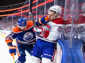 Canadiens' Evgenii Dadonov (63) is checked by Edmonton Oilers' Brett Kulak (27) during first period NHL action in Edmonton on Saturday, Dec. 3, 2022.