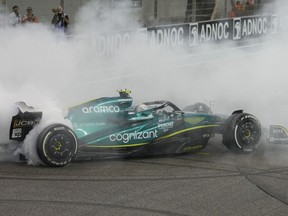 Aston Martin driver Sebastian Vettel of Germany burns the tires as he finished his last race in his career at the Formula One Abu Dhabi Grand Prix, in Abu Dhabi, United Arab Emirates, on Sunday, Nov. 20, 2022.