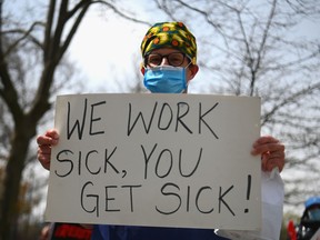Health care workers of Jacobi Medical Center in New York City hold a rally against a new paid sick leave policy in April 2020.