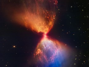 The James Webb Space Telescope unveiled its latest image of celestial majesty on Nov. 16, 2022, an ethereal hourglass of orange and blue dust being shot out from a newly forming star at its centre.