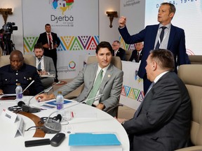 Burundi's president, Evariste Ndayishimiye, left, Canadian Prime Minister Justin Trudeau, centre, and Quebec Premier François Legault, lower right, attend a working session during a bilateral meeting at the 18th Francophone countries Summit in Djerba, on Saturday, Nov. 19, 2022.