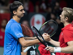 Italy's Lorenzo Sonego, left, shakes hand with Canada's Denis Shapovalov after men's single semi-final match at the Davis Cup tennis tournament match in Malaga, Spain on Saturday, Nov. 26, 2022.