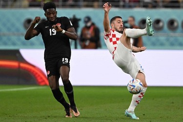 Canada's forward #19 Alphonso Davies and Croatia's defender #22 Josip Juranovic fight for the ball during the Qatar 2022 World Cup Group F football match between Croatia and Canada at the Khalifa International Stadium in Doha on Nov. 27, 2022.