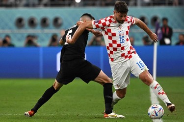 Canada's defender #05 Steven Vitoria and Croatia's forward #16 Bruno Petkovic fight for the ball during the Qatar 2022 World Cup Group F football match between Croatia and Canada at the Khalifa International Stadium in Doha on Nov. 27, 2022.