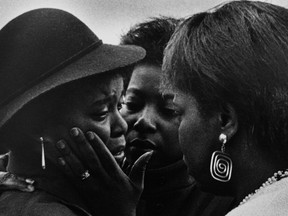 On Nov. 11, 1987, Montreal police officer Allan Gosset shot 19-year-old Anthony Griffin in the head after he tried to flee custody in the parking lot of Station 15 in N.D.G. During Griffin's funeral, family members comforted his mother, Gloria Augustus, left. Augustus understood how important this was and while she did not interact with the photographers, she did not shun us either. At one moment, a woman I believe to be an aunt of Anthony reached out and gave Gloria a brief, but tender touch, Montreal Gazette photographer Allen McInnis says.