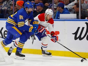 Buffalo Sabres' Alex Tuch pressures Montreal Canadiens right-wing Evgenii Dadonov during the second period in Buffalo on Oct. 27, 2022.