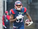 Montreal Alouettes' Eugene Lewis runs with the ball after scoring a touchdown against the Winnipeg Blue Bombers during first half in Montreal on Nov. 13, 2021.