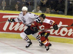 Oilers' Janne Ninimaa gives Flames' Martin St. Louis the business during a game in February 2000. St. Louis began his career in Calgary before achieving superstar status after signing with the Lightning as a free agent that July.