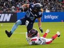 Toronto Argonauts running-back AJ Ouellette breaks a tackle by Montreal Alouettes defensive-back Najee Murray to score a touchdown during the first half CFL Eastern final at BMO Field in Toronto on Nov. 13, 2022.
