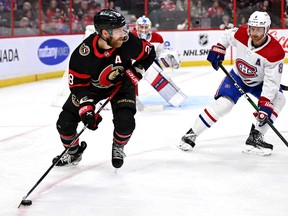 Ottawa Senators right wing Claude Giroux plays the puck in front of Montreal Canadiens defenceman Mike Matheson during second period in Ottawa on Oct. 1, 2022.