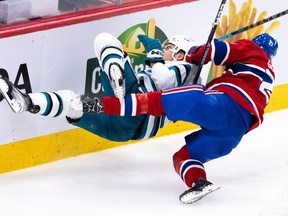 Montreal Canadiens defencemen Kaiden Guhle checks San Jose Sharks' Timo Meier during second period in Montreal on Nov. 29, 2022.