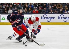 Columbus Blue Jackets left wing Johnny Gaudreau (13) and Montreal Canadiens defenceman Johnathan Kovacevic (26) battle for the puck in the first period at Nationwide Arena in Columbus, Ohio, on Nov. 17, 2022.