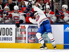Canadiens defenceman Arber Xhekaj (72) hits Columbus Blue Jackets centre Liam Foudy (19) into the Montreal Canadiens bench in the first period at Nationwide Arena in Columbus, Ohio, on Nov. 17, 2022.