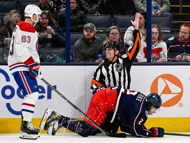 An official makes a penalty call against Montreal Canadiens right wing Evgenii Dadonov (63) while being run into by Columbus Blue Jackets defenceman Andrew Peeke (2) in the second period at Nationwide Arena in Columbus, Ohio, on Nov. 17, 2022.