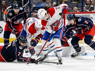 Canadiens right wing Cole Caufield (22) and Columbus Blue Jackets centre Sean Kuraly (7) fight for the puck in front of the Columbus Blue Jackets net in the second period at Nationwide Arena in Columbus, Ohio, on Nov. 17, 2022.