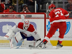Canadiens goaltender Jake Allen (34) makes a save on Detroit Red Wings center Dylan Larkin (71) in the first period at Little Caesars Arena in Detroit on Nov. 8, 2022.