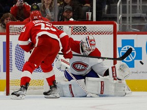 Montreal Canadiens goaltender Jake Allen (34) makes a save on Detroit Red Wings left wing Lucas Raymond (23) during a shootout at Little Caesars Arena Nov. 8, 2022.