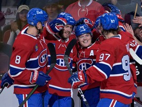 Canadiens defenceman Mike Matheson, left, celebrates Cole Caufield's goal with teammates during preseason game against the New Jersey Devils at the Bell Centre in Montreal on Sept. 26, 2022.
