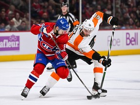 Philadelphia Flyers defenceman Justin Braun (61) plays the puck against Canadiens' Evgenii Dadonov (63) during the first period at the Bell Centre on Saturday, Nov. 19, 2022, in Montreal.