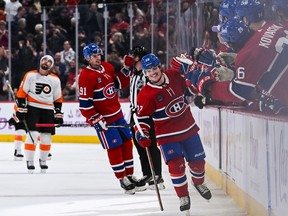 Canadiens' Cole Caufield (22) celebrates his tying goal with his teammates against the Philadelphia Flyers at Bell Centre in Montreal on Saturday, Nov. 20, 2022.