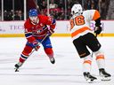 Montreal Canadiens centre Nick Suzuki crosses the blue line as Philadelphia Flyers left-wing Joel Farabee defends during overtime at the Bell Centre in Montreal on Nov. 19, 2022. 