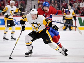 Pittsburgh Penguins forward Brock McGinn (23) plays the puck against Canadiens' Mike Hoffman (68) during the first period at the Bell Centre on Saturday, Nov. 12, 2022, in Montreal.
