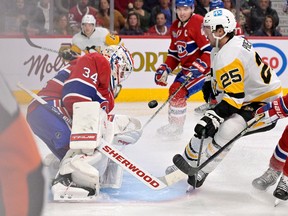 Canadiens goalie Jake Allen stops Pittsburgh Penguins forward Ryan Poehling (25) during the third period at the Bell Centre on Saturday, Nov. 22, 2022.