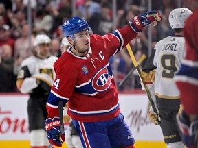 Canadiens forward Nick Suzuki (14) celebrates with teammates after scoring a goal against the Vegas Golden Knights during the third period at the Bell Centre  on Saturday, Nov. 5, 2022.