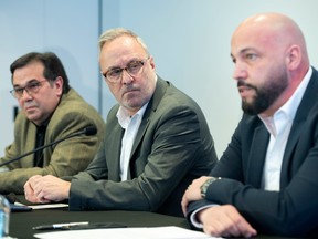 FTQ president Daniel Boyer, centre, CSQ president Eric Gingras, right, and CSN first vice-president François Enault speak during a news conference in Montreal Sunday, April 3, 2022.