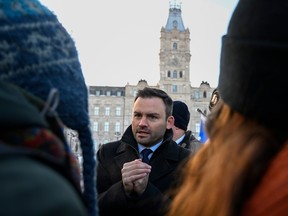 Paul St-Pierre Plamondon meets demonstrators in front of the National Assembly on Tuesday. "I am an elected member of parliament and I want to be part of that parliament," the Parti Québécois leader said.