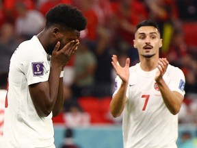 Canada's Alphonso Davies looks dejected after having a penalty kick saved by Belgium's Thibaut Courtois at the Ahmad Bin Ali Stadium.