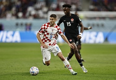 Croatia's Andrej Kramaric in action with Canada's Ismael Kone during the Qatar 2022 World Cup Group F football match between Croatia and Canada at the Khalifa International Stadium in Doha on Nov. 27, 2022.