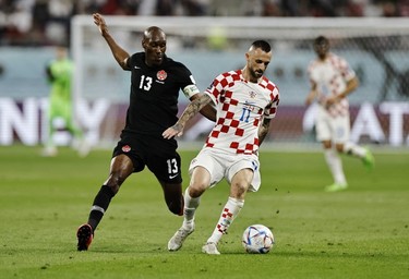 Croatia's Marcelo Brozovic in action with Canada's Atiba Hutchinson during the Qatar 2022 World Cup Group F football match between Croatia and Canada at the Khalifa International Stadium in Doha on Nov. 27, 2022.