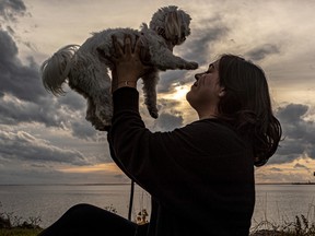Dog lovers like Amanda Asimakopoulos with her 3-year-old Morkie (a cross between a Maltese and Yorkshire Terrier), Rosie took advantage of the record-breaking warm temperatures in Montreal Nov. 5, 2022.