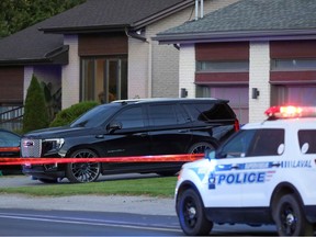 Police tape marks the scene where Davide Barberio was shot outside his Laval home in September 2021.