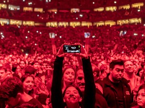 Nov. 25: The first thing I do when shooting a concert from the pit is look for one or two photos of the fans. It makes for a good addition to the online gallery. Everyone was bathed in red before the start of Stromae's Bell Centre show, which I thought was pretty cool. At first the fans would wave or make hearts, but one person got creative, and that made her a standout for this shot.