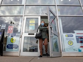 A woman exits the COVID vaccination centre in Kirkland under cloudy skies Dec. 1, 2022.