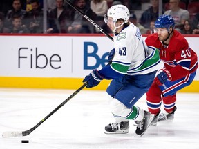 Montreal Canadiens right wing Joel Armia stays close to Vancouver Canucks defenceman Quinn Hughes at the Bell Centre in Montreal on Wednesday, November 9, 2022.