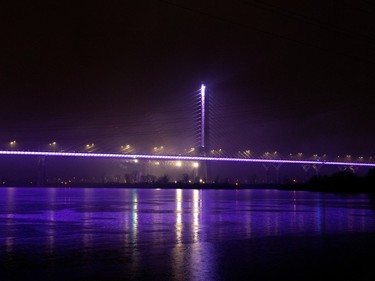 The Samuel de Champlain Bridge, lit up in purple and white to mark the National Day of Remembrance and Action on Violence Against Women, in Montreal, on Tuesday, December 6, 2022.