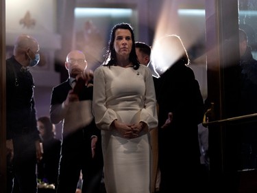 Mayor of Montreal, Valérie Plante, takes a moment to view the 14 white beams of light projected in to the sky as part of the ceremonies to mark the anniversary of the massacre at Ecole Polytechnique in Montreal, on Tuesday, Dec. 6, 2022.