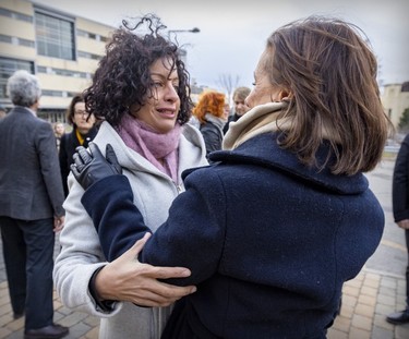 Former Quebec Liberal leader and Polytechnique graduate Dominique Anglade, left, embraces École Polytechnique director general Maud Cohen following a ceremony remembering the victims of the 1989 massacre held on Dec. 6, 2022