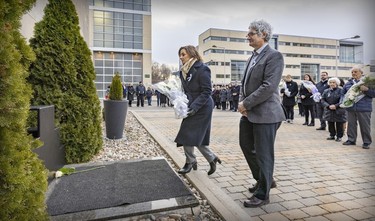 École Polytechnique director general Maud Cohen, accompanied by interim director of academic affairs Pierre Baptiste, carries white roses to the December 6 commemorative plaque during a ceremony remembering the victims of the 1989 massacre held on Dec. 6, 2022