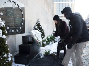 Clara Levy-Provençal and Joël Girard-Lauzièrehe lay down flowers at the base of the plaque commemorating the 14 women killed at the Polytechnique on the 27th anniversary of the Dec. 6 massacre.