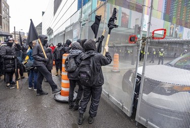 Anti-capitalist demonstrators hit the security fence around the Palais des congrès during the COP15 conference in Montreal on Dec. 7, 2022
