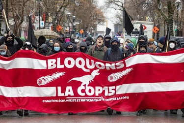 Anti-capitalist demonstrators walk through the streets of Montreal protesting the COP15 conference on Dec. 7, 2022