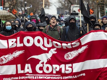 Anti-capitalist demonstrators walk through the streets of Montreal protesting the COP15 conference on Dec. 7, 2022